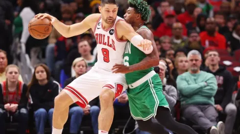 Nikola Vucevic of the Chicago Bulls drives to the basket against Marcus Smart of the Boston Celtics
