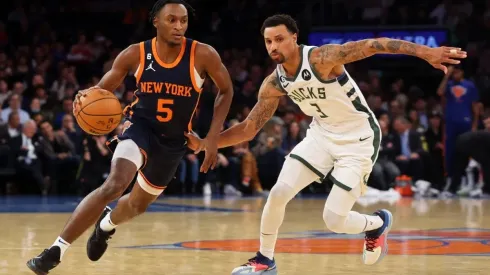 Immanuel Quickley of the New York Knicks drives to the net against George Hill of the Milwaukee Bucks
