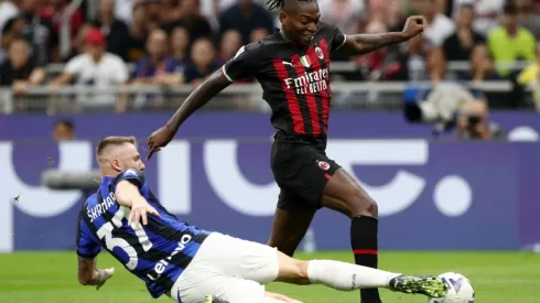 Milan Skriniar of FC Internazionale challenges Rafael Leao of AC Milan