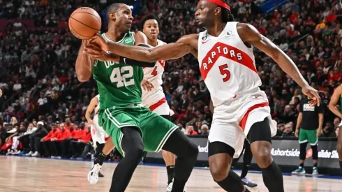 Al Horford of the Boston Celtics protects the ball from Precious Achiuwa of the Toronto Raptors