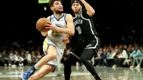 Ty Jerome #10 of the Golden State Warriors drives to the basket against Seth Curry #30 of the Brooklyn Nets
