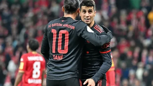 Leroy Sane of Bayern Munich celebrates with Joao Cancelo
