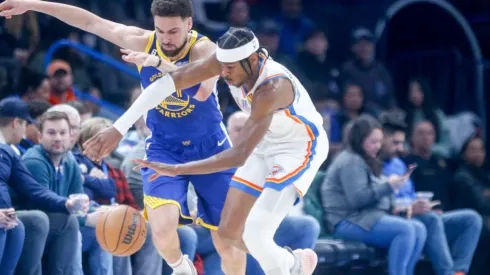 Shai Gilgeous-Alexander #2 of the Oklahoma City Thunder steals the ball from Klay Thompson #11 of the Golden State Warriors