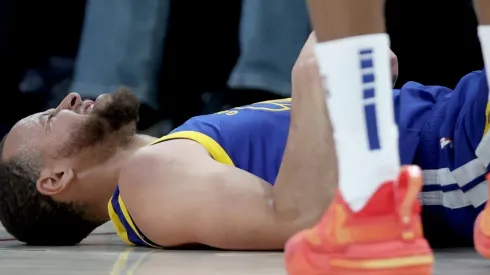 Stephen Curry #30 of the Golden State Warriors is knocked to the floor
