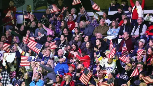 Fans wave American flags
