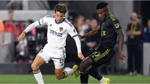 Riqui Puig #6 of Los Angeles Galaxy controls the ball against Jose Cifuentes #20 of Los Angeles FC
