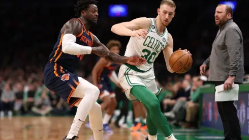 Julius Randle #30 of the New York Knicks defends Sam Hauser #30 of the Boston Celtics
