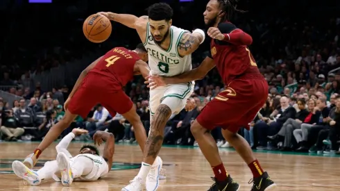 Jayson Tatum #0 of the Boston Celtics drives on Darius Garland #10 of the Cleveland Cavaliers
