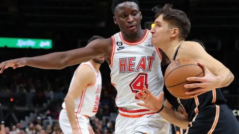 Bogdan Bogdanovic #13 of the Atlanta Hawks draws a foul from Victor Oladipo #4 of the Miami Heat
