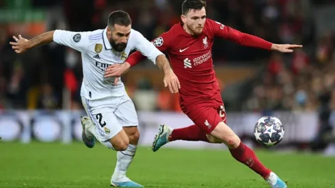 Andrew Robertson of Liverpool runs with the ball whilst under pressure from Daniel Carvajal of Real Madrid
