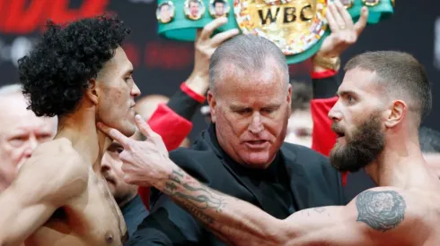 Super middleweight boxers David Benavidez (L) and Caleb Plant get into a scuffle as they face off
