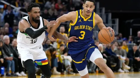 Jordan Poole #3 of the Golden State Warriors drives towards the basket past Mike Conley #10 of the Minnesota Timberwolves
