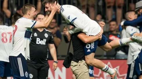 Tristan Blackmon of the Vancouver Whitecaps FC celebrates with teammate Julian Gressel
