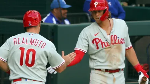 J.T. Realmuto #10 of the Philadelphia Phillies is greeted by teammate Alec Bohm