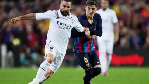 Daniel Carvajal of Real Madrid battles for possession with Gavi of FC Barcelona
