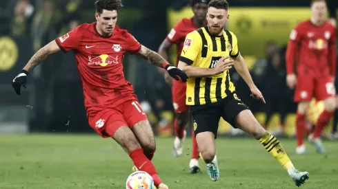 Salih Oezcan of Dortmund (R) challenges Dominik Szoboszlai of Leipzig
