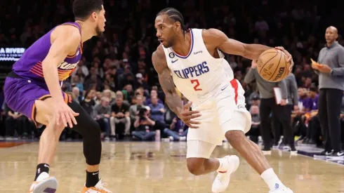 Kawhi Leonard #2 of the LA Clippers handles the ball against Devin Booker #1 of the Phoenix Suns