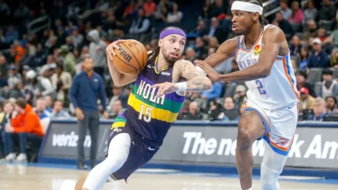 Jose Alvarado #15 of the New Orleans Pelicans drives past Shai Gilgeous-Alexander #2 of the Oklahoma City Thunder
