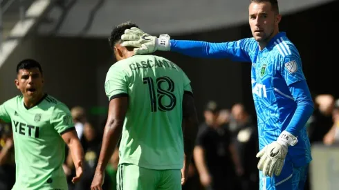 Goalkeeper Brad Stuver #1 congratulates Julio Cascante #18 of Austin FC
