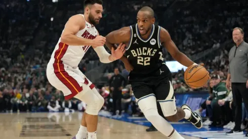Khris Middleton #22 of the Milwaukee Bucks dribbles the ball against Max Strus #31 of the Miami Heat