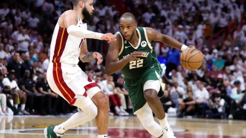 Khris Middleton #22 of the Milwaukee Bucks dribbles the ball against Caleb Martin #16 of the Miami Heat