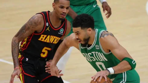 Jayson Tatum #0 of the Boston Celtics drives against Dejounte Murray #5 of the Atlanta Hawks
