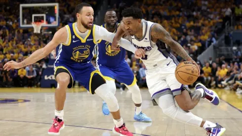 Malik Monk #0 of the Sacramento Kings is guarded by Stephen Curry #30 of the Golden State Warriors
