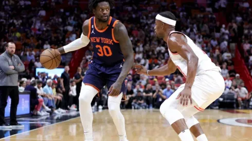 Julius Randle #30 of the New York Knicks dribbles the ball against Jimmy Butler #22 of the Miami Heat
