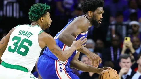 Joel Embiid #21 of the Philadelphia 76ers drives past Marcus Smart #36 of the Boston Celtics
