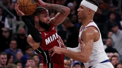 Caleb Martin #16 of the Miami Heat tries to pass as Josh Hart #3 of the New York Knicks
