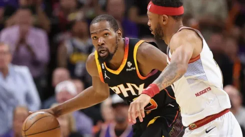 Kevin Durant #35 of the Phoenix Suns handles the ball against Bruce Brown #11 of the Denver Nuggets
