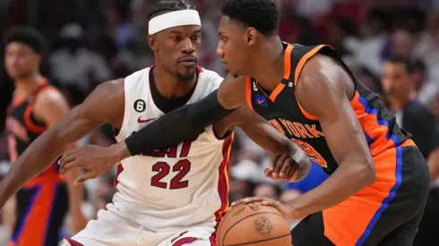 RJ Barrett #9 of the New York Knicks dribbles upcourt while being defended by Jimmy Butler #22 of the Miami Heat
