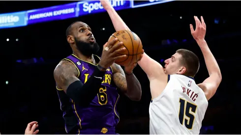 LeBron James #6 of the Los Angeles Lakers takes a shot against Nikola Jokic #15 of the Denver Nuggets
