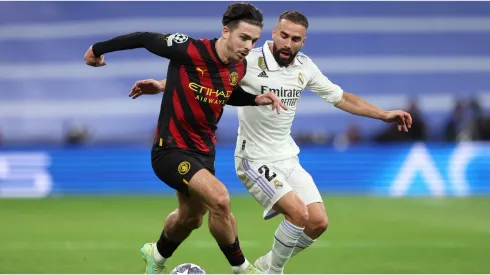 Daniel Carvajal of Real Madrid battles for possession with Jack Grealish of Manchester City
