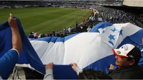 Fans of Honduras wave a flag