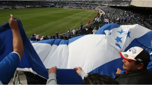 Fans of Honduras wave a flag
