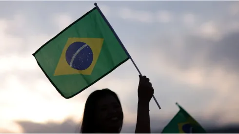 Fans wave a Brazil flag outside the stadium