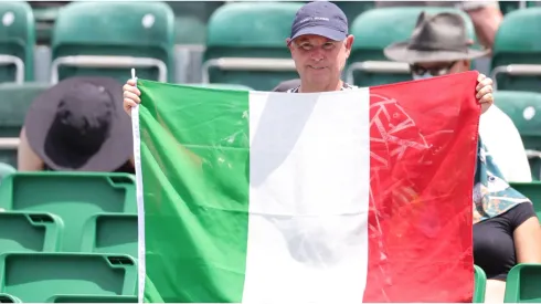 A fan holds an Italian flag