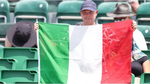 A fan holds an Italian flag
