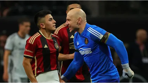 Thiago Almada #23 of Atlanta United reacts with goalkeeper Brad Guzan
