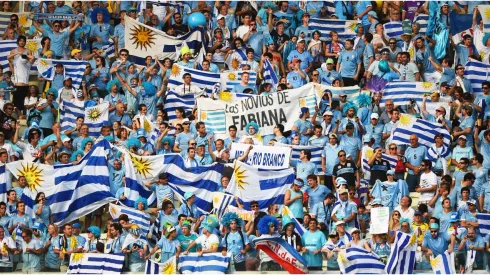 Uruguay fans hold up their country's flags
