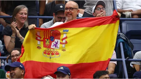 A fan holds up the flag of Spain
