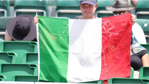 A fan holds an Italian flag
