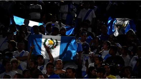 Fans hold up flags before
