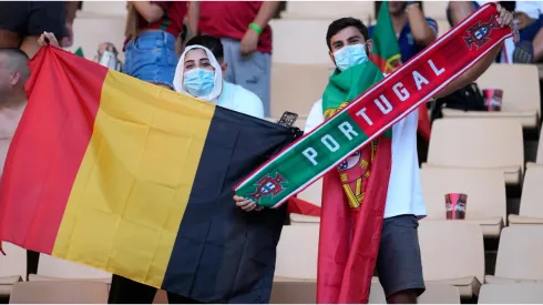 Fans of Belgium and Portugal wave a flag and a scarf
