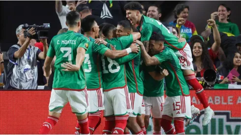 Teammates celebrate with Henry Martin #20 of Mexico
