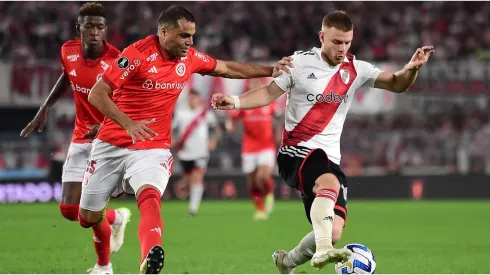 Lucas Beltrán of River Plate competes for the ball with Gabriel Mercado of Internacional