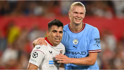 Marcos Acuna of Sevilla FC reacts with Erling Haaland of Manchester City
