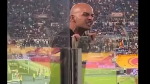 AC Milan fan yelling at Roma supporters.
