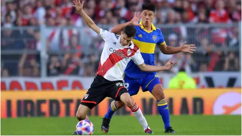  Ignacio Fernández of River Plate competes for the ball with Facundo Roncaglia of Boca Juniors
